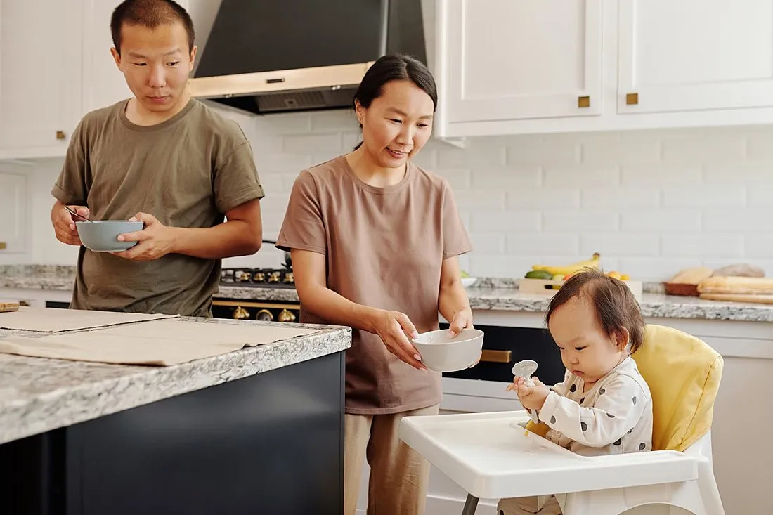 a child safely eating peanut butter with a parent