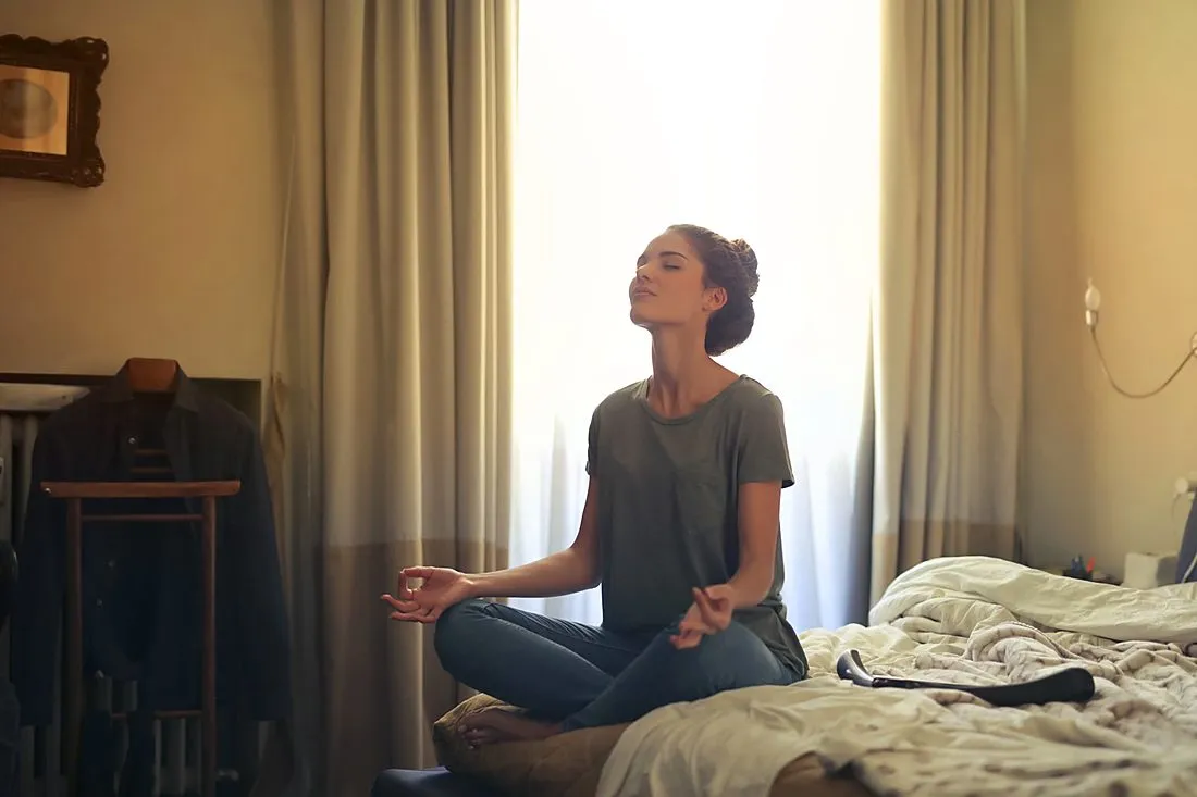 a person meditating quietly in a sunlit room
