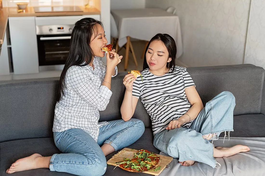 two friends sharing a meal on a front porch