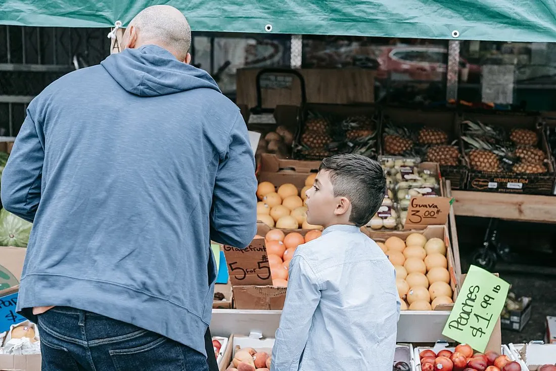 a father and son building a wooden farm stand together