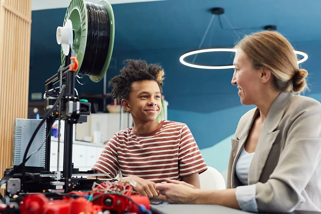 a teenage boy with a 3D printer