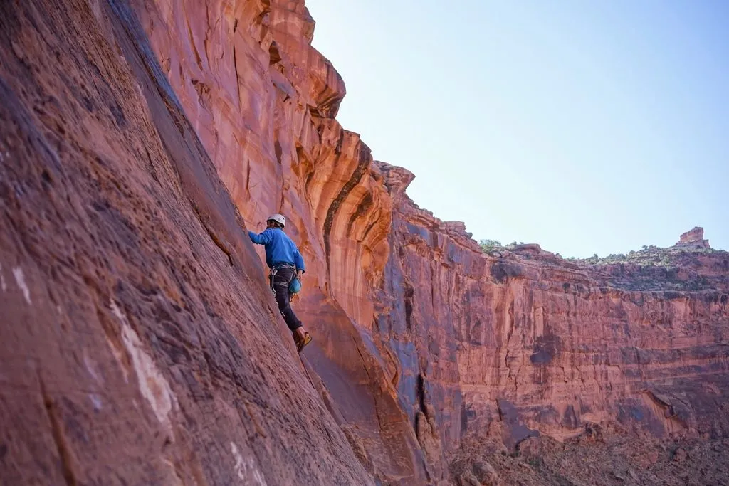 a rock climber scaling a cliff
