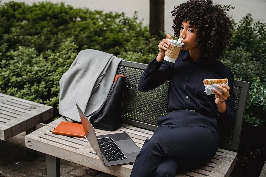 a person on a lunch break sitting in a small city park