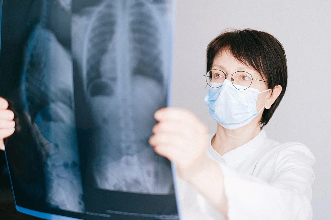 a doctor reviewing a chest CT scan with an older patient