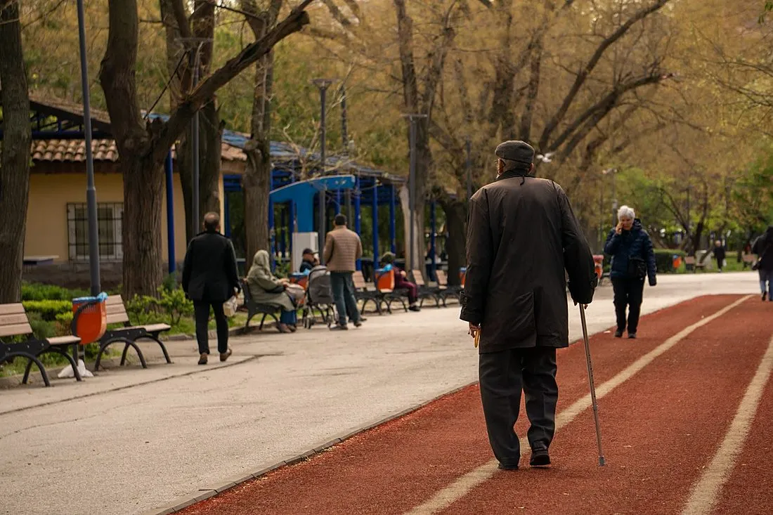 an older adult walking briskly outdoors