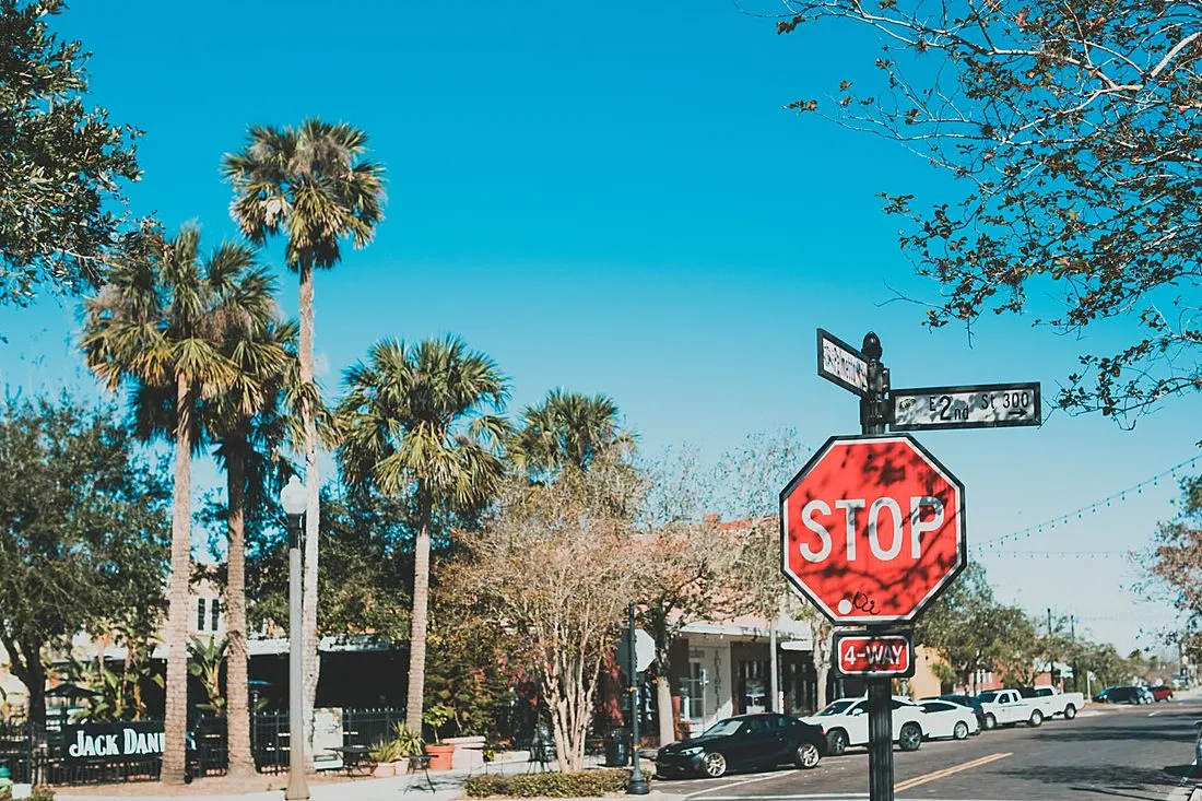 a city street intersection with a crosswalk and stop signs